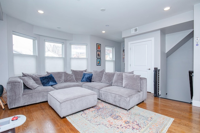 living area featuring recessed lighting, visible vents, and light wood-style floors