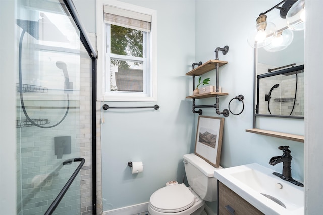 bathroom featuring vanity, toilet, and a shower with shower door