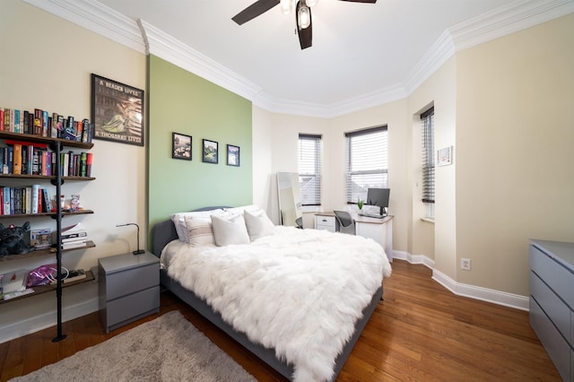 bedroom with ornamental molding, dark wood-type flooring, and ceiling fan