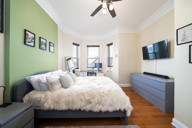 bedroom with crown molding, hardwood / wood-style floors, and ceiling fan