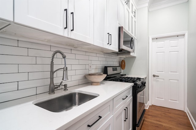 kitchen with white cabinetry, sink, dark wood-type flooring, and stainless steel appliances