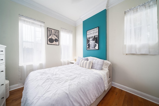 bedroom with crown molding and dark hardwood / wood-style floors