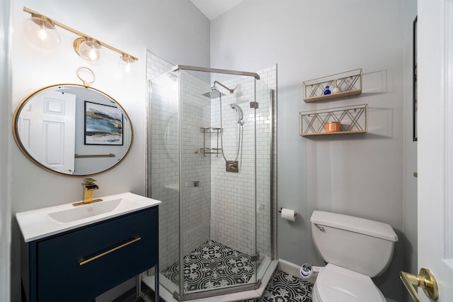 bathroom featuring walk in shower, vanity, and toilet