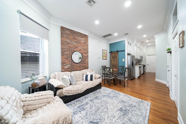 living room featuring dark hardwood / wood-style floors, ornamental molding, and a barn door