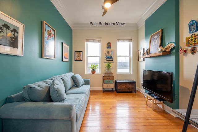 living room featuring crown molding and light hardwood / wood-style flooring