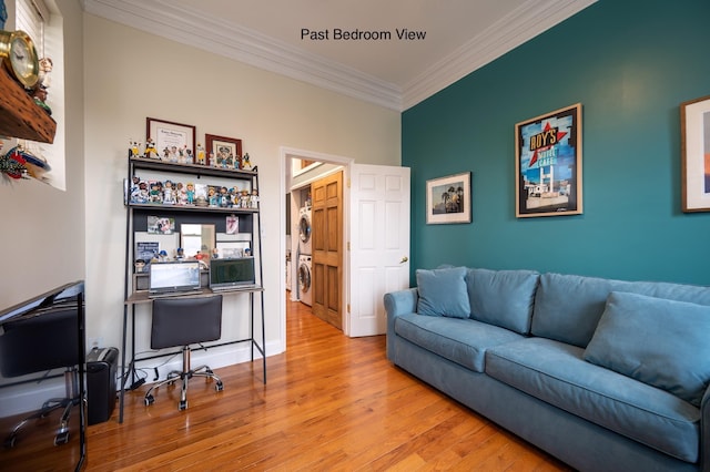 office space featuring light hardwood / wood-style flooring, ornamental molding, and stacked washer / dryer