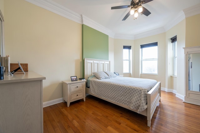 bedroom featuring crown molding, ceiling fan, and dark hardwood / wood-style floors