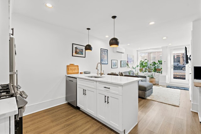 121 Coles St Unit 1, Jersey City, NJ 07306 - kitchen with a peninsula, appliances with stainless steel finishes, open floor plan, white cabinets, and light wood finished floors