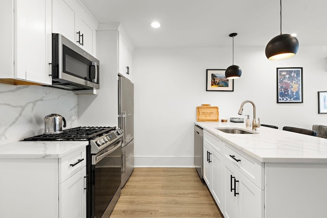 121 Coles St Unit 1, Jersey City, NJ 07306 - kitchen featuring stainless steel appliances, a sink, a peninsula, baseboards, and tasteful backsplash