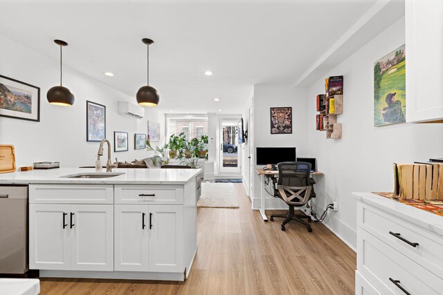 121 Coles St Unit 1, Jersey City, NJ 07306 - kitchen featuring a wall unit AC, dishwasher, a sink, white cabinetry, and open floor plan