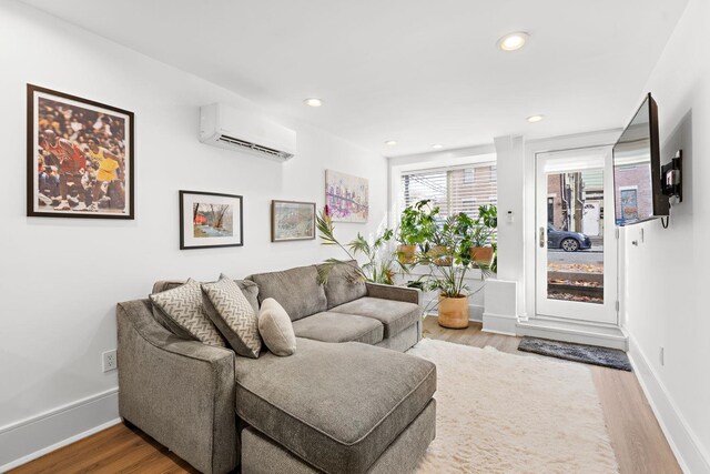 121 Coles St Unit 1, Jersey City, NJ 07306 - living room featuring a wall mounted AC, wood finished floors, baseboards, and recessed lighting