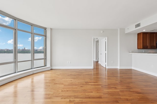8100 River Rd Unit 1215, North Bergen, NJ 07047 - unfurnished living room featuring light wood-type flooring and a water view