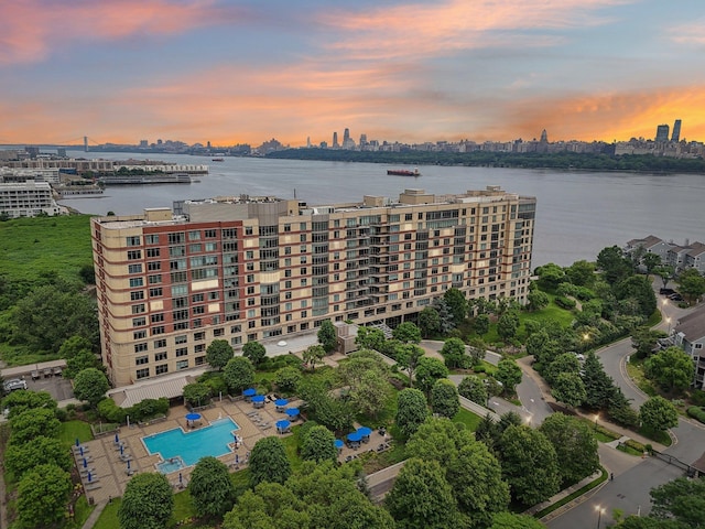 8100 River Rd Unit 1215, North Bergen, NJ 07047 - aerial view at dusk of a skyline view, view of pool area, and a water view