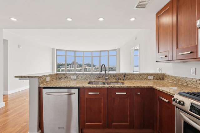 8100 River Rd Unit 1215, North Bergen, NJ 07047 - kitchen with light stone counters, a peninsula, recessed lighting, light wood-type flooring, and stainless steel appliances