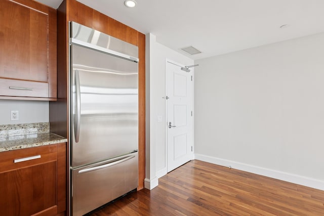 8100 River Rd Unit 1215, North Bergen, NJ 07047 - kitchen featuring stainless steel built in fridge, dark wood-style flooring, brown cabinetry, light stone countertops, and recessed lighting