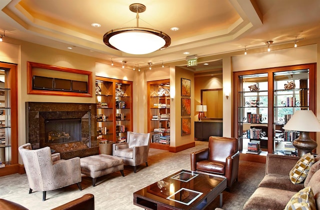 8100 River Rd Unit 1215, North Bergen, NJ 07047 - living area featuring a tray ceiling, a high end fireplace, and built in shelves