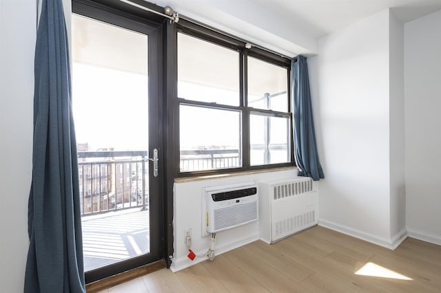 500 Central Ave Unit 520, Union City, NJ 07087 - entryway featuring baseboards, radiator heating unit, wood finished floors, and a wall mounted AC