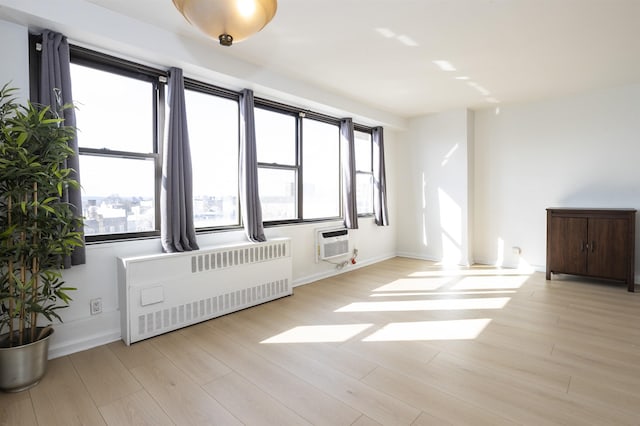 500 Central Ave Unit 520, Union City, NJ 07087 - empty room with radiator, a wealth of natural light, and light wood-style floors
