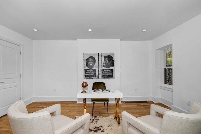 sitting room with hardwood / wood-style flooring