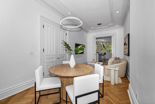 dining room featuring ornamental molding and light parquet flooring