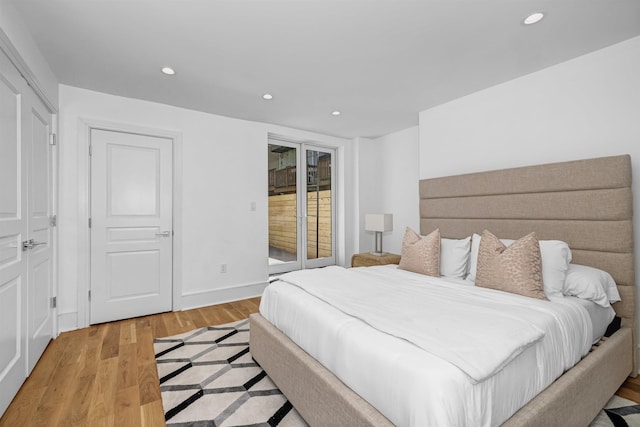 bedroom with light hardwood / wood-style flooring and access to outside