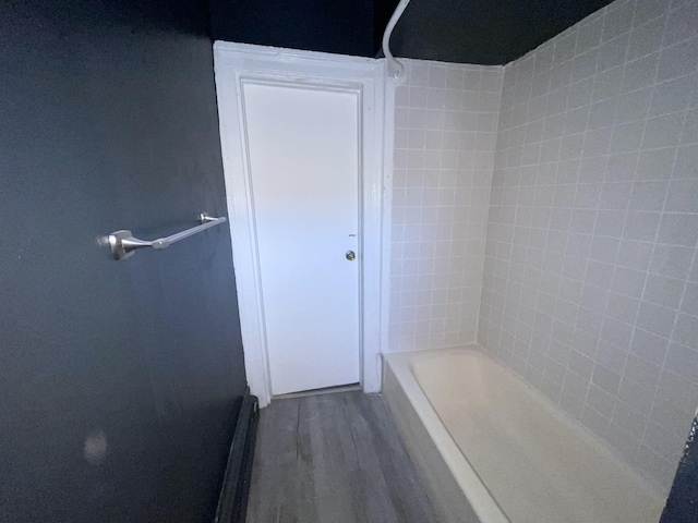 full bathroom featuring bathtub / shower combination and wood finished floors