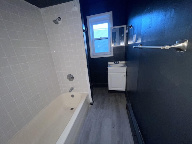 full bathroom featuring shower / bath combination, wood finished floors, and vanity