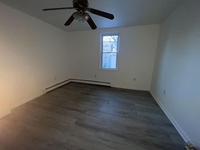 spare room with baseboard heating and wood finished floors