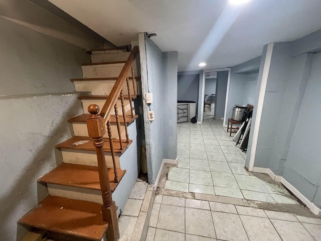 staircase with tile patterned flooring and baseboards