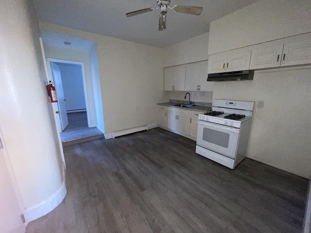 kitchen with under cabinet range hood, a sink, gas range gas stove, white cabinets, and baseboard heating