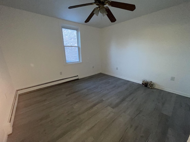 spare room with ceiling fan, dark wood-style floors, baseboards, and a baseboard radiator