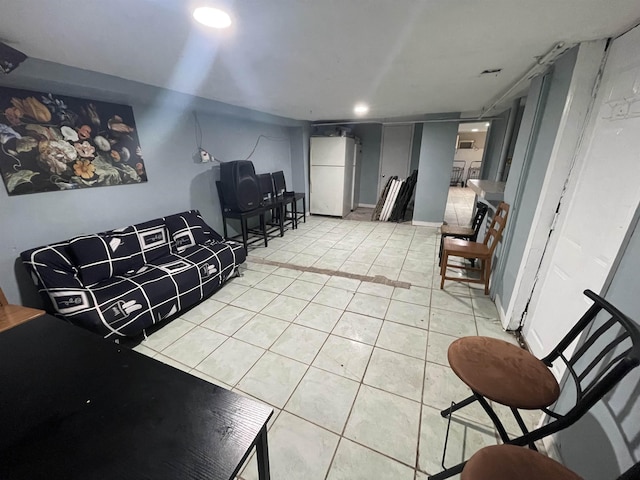 living area featuring light tile patterned floors, baseboards, and recessed lighting