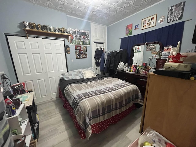 bedroom featuring an ornate ceiling and wood finished floors