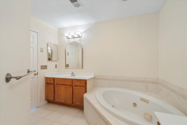 full bathroom featuring a jetted tub, tile patterned flooring, visible vents, and vanity