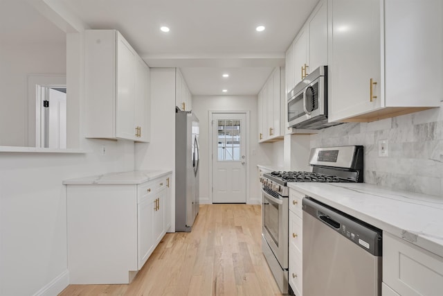 115 Wilson Ave, Rutherford, NJ 07070 - kitchen featuring stainless steel appliances, light wood-style flooring, white cabinets, baseboards, and recessed lighting