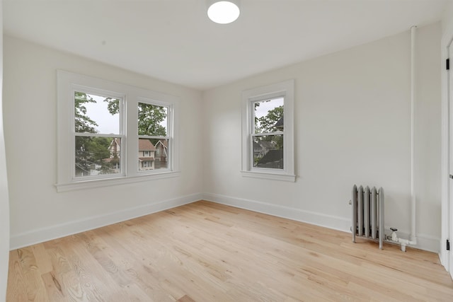 115 Wilson Ave, Rutherford, NJ 07070 - spare room with radiator heating unit, plenty of natural light, and light wood finished floors