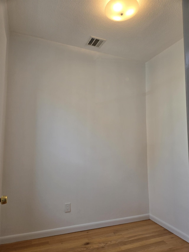 29 48th St, Weehawken, NJ 07086 - empty room with a textured ceiling, visible vents, wood finished floors, and baseboards