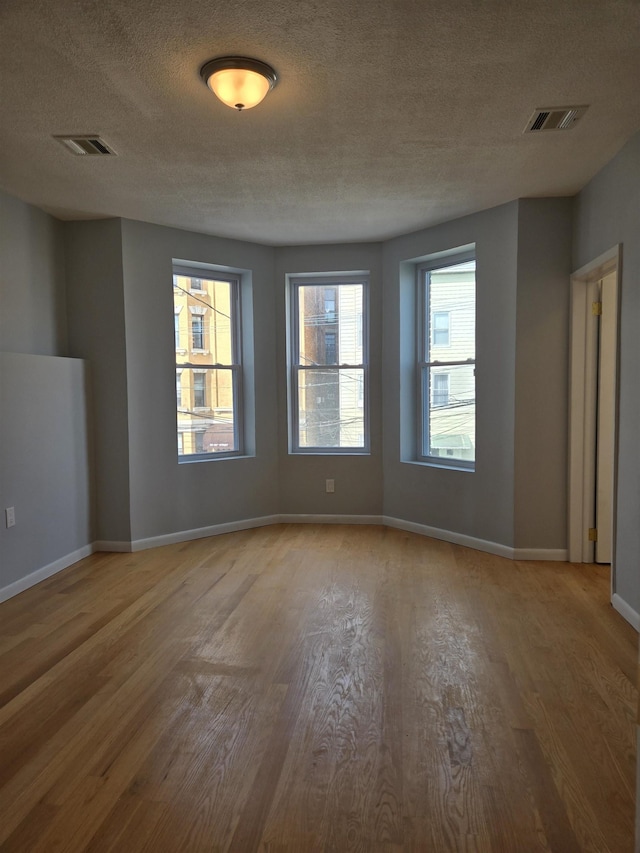 29 48th St, Weehawken, NJ 07086 - spare room with a textured ceiling, wood finished floors, visible vents, and baseboards