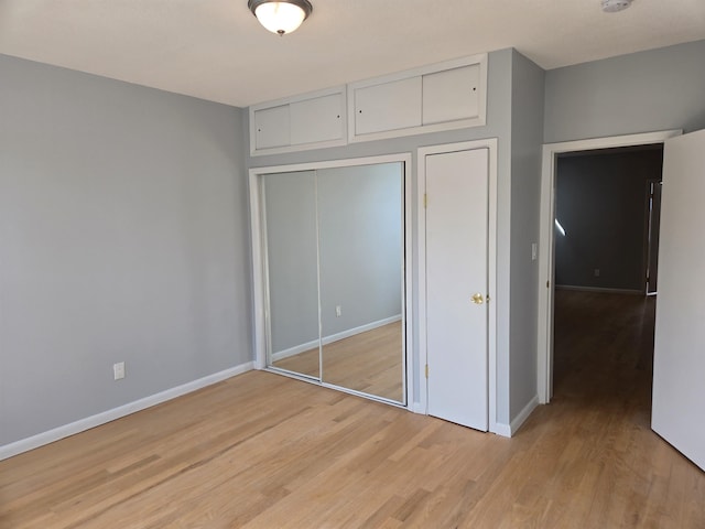 29 48th St, Weehawken, NJ 07086 - unfurnished bedroom with baseboards, light wood-style floors, and a closet