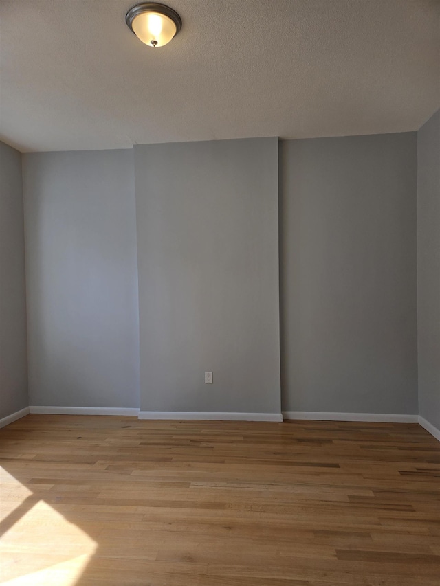 29 48th St, Weehawken, NJ 07086 - spare room featuring baseboards, light wood-style floors, and a textured ceiling