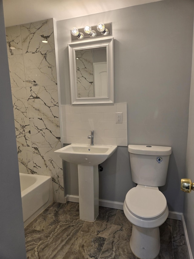 29 48th St, Weehawken, NJ 07086 - bathroom with baseboards, backsplash, toilet, and marble finish floor
