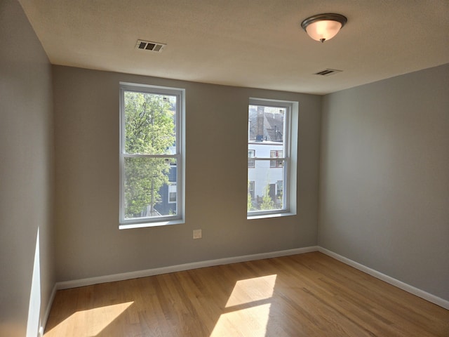 29 48th St, Weehawken, NJ 07086 - empty room featuring visible vents, wood finished floors, and baseboards