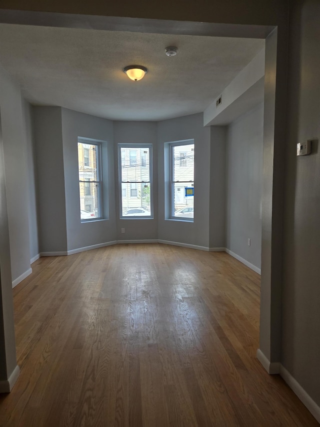 29 48th St, Weehawken, NJ 07086 - empty room featuring wood finished floors and baseboards