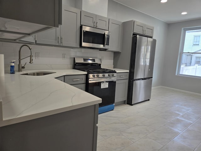 29 48th St, Weehawken, NJ 07086 - kitchen featuring gray cabinets, light stone counters, stainless steel appliances, marble finish floor, and a sink