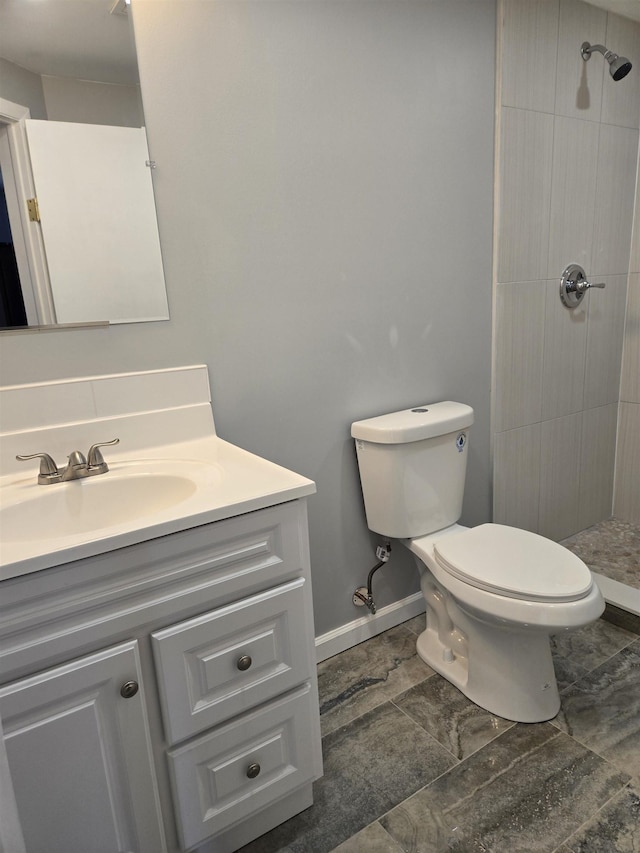 29 48th St, Weehawken, NJ 07086 - full bathroom with a tile shower, toilet, vanity, and baseboards