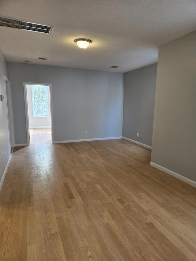 29 48th St, Weehawken, NJ 07086 - unfurnished room with wood finished floors, visible vents, and baseboards
