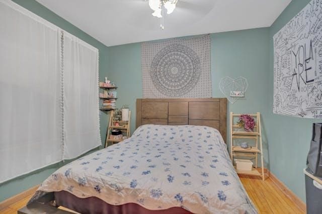 bedroom featuring wood-type flooring and ceiling fan