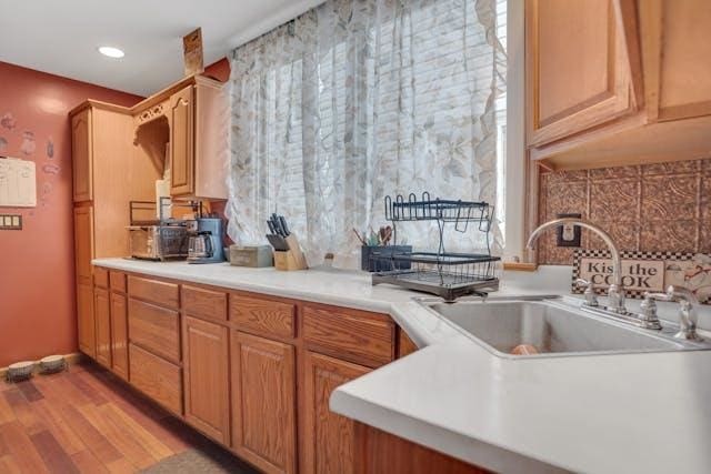 kitchen with sink and light hardwood / wood-style floors