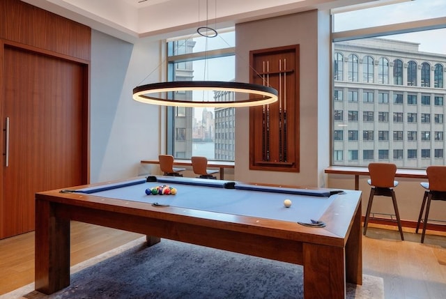 game room with light hardwood / wood-style flooring and billiards