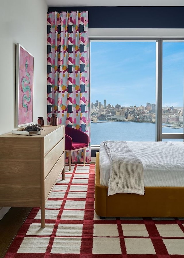 bedroom featuring multiple windows and a water view